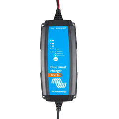 Victron Blue Smart 12V 7A waterproof battery charger with blue display showing status indicators and mode button, mounted in